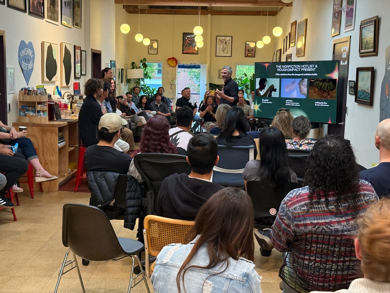 Audience gathered for a Rough Impact presentation in the Fancy Film atrium